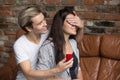 Happy young man propose to his girlfriend sitting on couch Royalty Free Stock Photo
