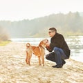 Young happy man playing with his dog Royalty Free Stock Photo