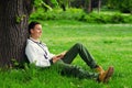 Young happy man reading book in the nature Royalty Free Stock Photo