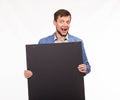 Young happy man showing presentation, pointing on placard