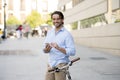 Young happy man smiling using mobile phone on vintage cool retro bike Royalty Free Stock Photo