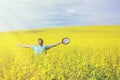 Young happy man standing on a meadow with raising hands and looking to a sky. Royalty Free Stock Photo