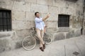 Young happy man taking selfie with mobile phone on retro cool vintage bike Royalty Free Stock Photo