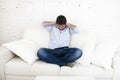 Young happy man watching television horror movie covering his ears scared and horrified Royalty Free Stock Photo