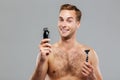 Young happy man what razor to choose Royalty Free Stock Photo