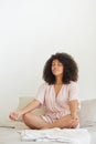 Young happy mixed race woman practicing yoga and doing breathing exercises. Royalty Free Stock Photo