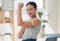 Young happy mixed race woman showing and holding her arm with a bandaid after getting a vaccine. Beautiful and confident Royalty Free Stock Photo