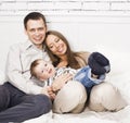Young happy modern family smiling together at home. lifestyle people concept, father holding baby son Royalty Free Stock Photo