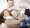 Young happy modern family smiling together at home. lifestyle people concept, father holding baby son Royalty Free Stock Photo