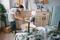 Young happy mom and her baby cook cookies at home in the kitchen. Christmas Homemade Gingerbread. cute boy with mother in white Royalty Free Stock Photo