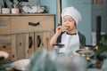 Young happy mom and her baby cook cookies at home in the kitchen. Christmas Homemade Gingerbread. cute boy with mother in white Royalty Free Stock Photo