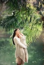 Young and happy mother cares for her young son, and walks along the shore of the lake in the summer in the park Royalty Free Stock Photo