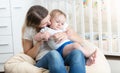 Portrait of young happy mother embracing her 10 months baby boy Royalty Free Stock Photo