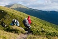 Young happy mother hold little traveller on back - baby girl in carrying backpack enjoying travel adventure, Hiking activity with