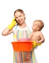 Young happy mother is a housewife with a baby does homework and Royalty Free Stock Photo