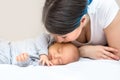 Young mother is kissing her newborn son