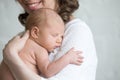 Young happy mother tenderly hugging her newborn baby Royalty Free Stock Photo