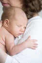 Young happy mother tenderly hugging her newborn baby Royalty Free Stock Photo