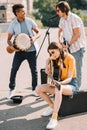 Young and happy multiracial male and female street musicians Royalty Free Stock Photo