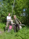 Young happy pair at a well,pours water.Portrait Royalty Free Stock Photo