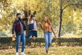 Happy parents having fun with their boy while running in the park during autumn day Royalty Free Stock Photo