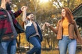 Happy parents having fun with their boy while running in the park during autumn day Royalty Free Stock Photo