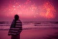 Young happy patriot girl holding the American flag on the 4th of July and looks at the salute Royalty Free Stock Photo