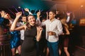 Happy people are dancing in club. Nightlife and disco concept Royalty Free Stock Photo