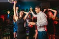 Happy people are dancing in club. Nightlife and disco concept Royalty Free Stock Photo