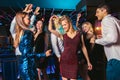 Happy people are dancing in club. Nightlife and disco concept Royalty Free Stock Photo