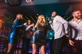 Happy people are dancing in club. Nightlife and disco concept Royalty Free Stock Photo