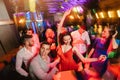 Happy people are dancing in club. Nightlife and disco concept Royalty Free Stock Photo