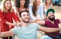 Young happy people having fun together on shopping carts - Multiracial friends sharing funny time with trolleys at commercial mall