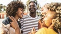 Young happy people laughing together - Multiracial friends group having fun on city street - Diverse culture students portrait Royalty Free Stock Photo