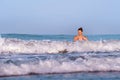 Young happy and playful red hair woman in bikini swimming on the sea playing with big waves enjoying Summer holidays paradise Royalty Free Stock Photo