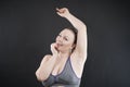 Young happy plus size caucasian woman shows her unshaved armpit Royalty Free Stock Photo