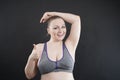 Young happy plus size caucasian woman shows her unshaved armpit Royalty Free Stock Photo