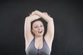 Young happy plus size caucasian woman shows her unshaved armpit