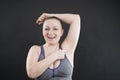 Young happy plus size caucasian woman shows her unshaved armpit Royalty Free Stock Photo