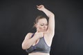 Young happy plus size caucasian woman shows her unshaved armpit Royalty Free Stock Photo