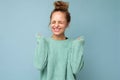 Young happy positive emotional attractive blonde woman with sincere emotions wearing casual blue sweater isolated on Royalty Free Stock Photo