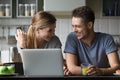 Young happy couple talking and laughing having breakfast with la Royalty Free Stock Photo