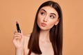 young happy positive woman holding pink lipstick Royalty Free Stock Photo