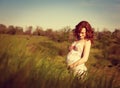 Young happy pregnant woman relaxing and enjoying life in nature. Royalty Free Stock Photo