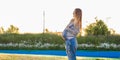 Young happy pregnant woman relaxing and enjoying life in nature. Outdoor shot. Copyspace Royalty Free Stock Photo