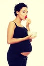 Young happy pregnant woman with strawberries Royalty Free Stock Photo