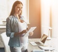 Young Happy Pregnant Woman Using Digital Tablet. Royalty Free Stock Photo