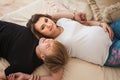 Young happy pregnant woman resting with handsome man on luxury bed Royalty Free Stock Photo