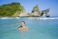 Young happy and pretty Asian Korean tourist woman enjoying swimming at tropical paradise beach island with tourquoise cyan sea wat Royalty Free Stock Photo