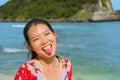 Young happy and pretty tourist Asian Korean woman in Summer dress enjoying tropical paradise beach holidays posing playful in fron Royalty Free Stock Photo